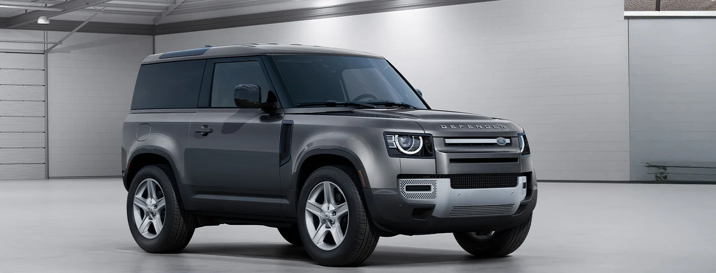 Parked gray 2025 Defender 130 in a warehouse