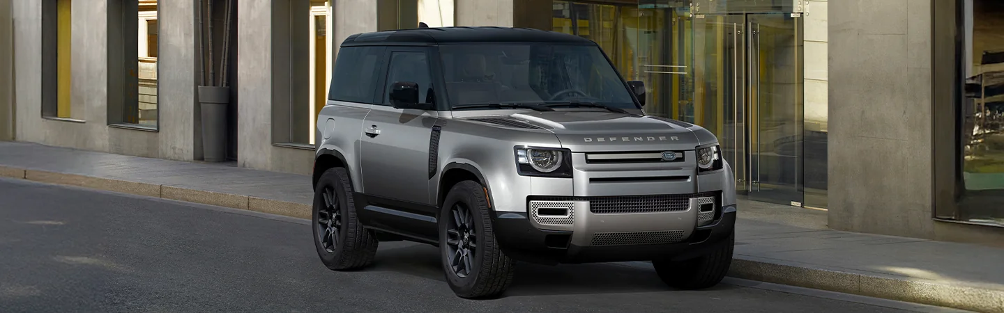 Gray 2025 Defender 130 parked on a city street