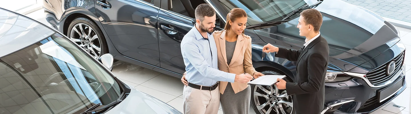 couple speaking with dealership representative about a test Drive a New Volkswagen Today