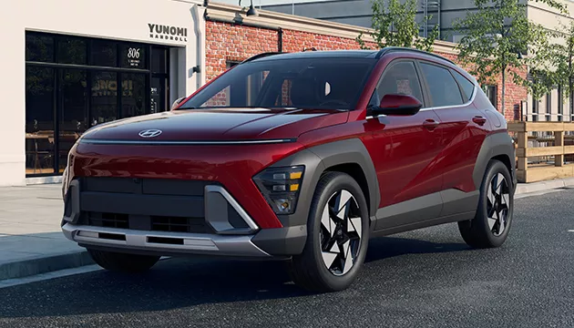 Front view of a parked red Hyundai SUV on a city street.