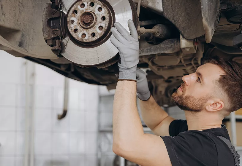 Service tech at Crown Hyundai working on changing brakes