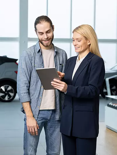 Subaru driver reviewing buying and leasing options at Crown Subaru