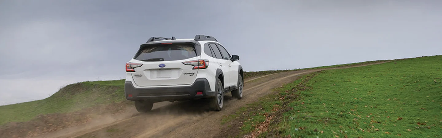 a rear view of a white 2025 Subaru Outback Touring