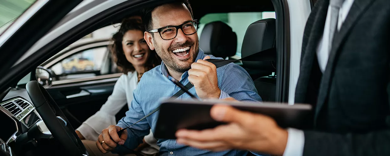 Customers being shown the interior of a new vehicle
