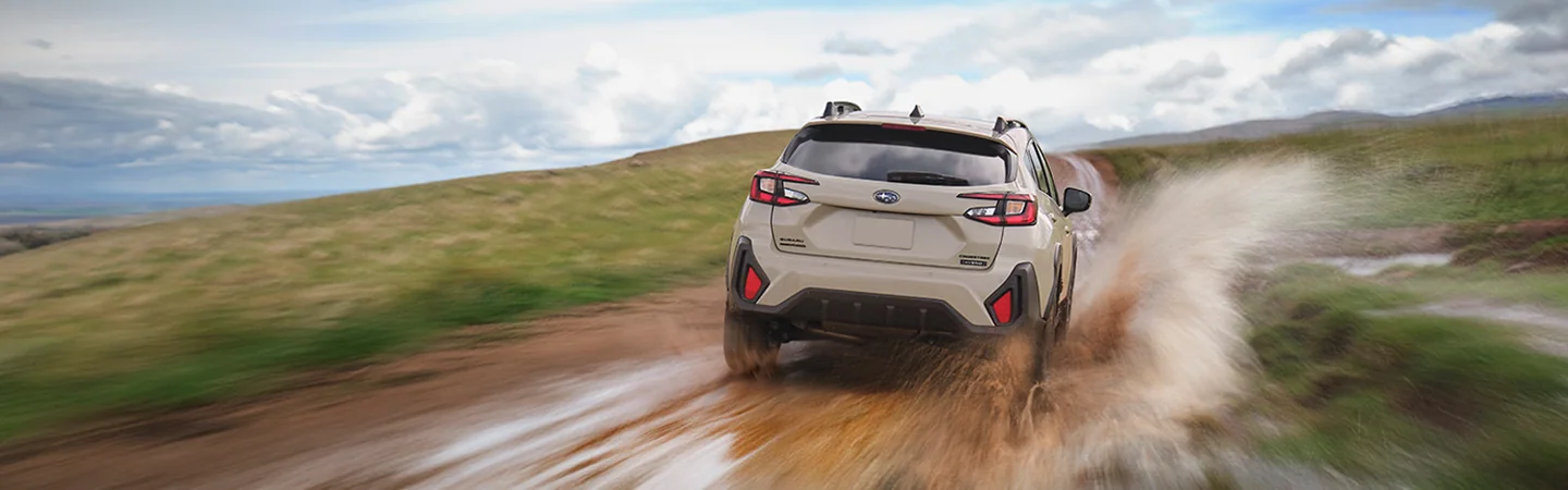 rear view of a 2026 Subaru Crosstrek Sport Hybrid on muddy road