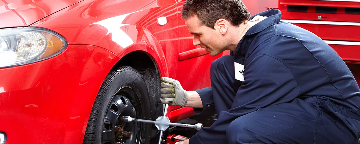 Service mechanic changing the tires on a vehicle