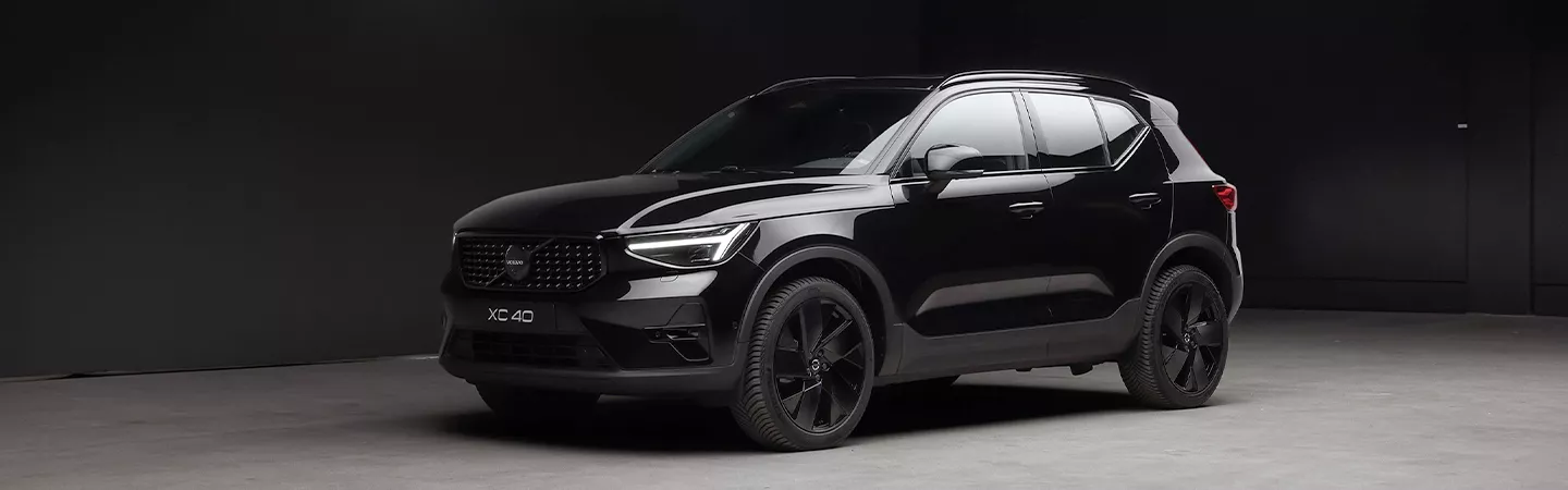 Front view of a 2026 Volvo XC40 parked in a dark parking lot