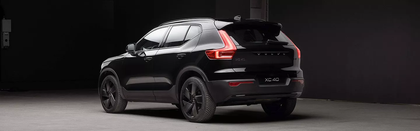 Rear view of a 2026 Volvo XC40 parked in a dark parking lot