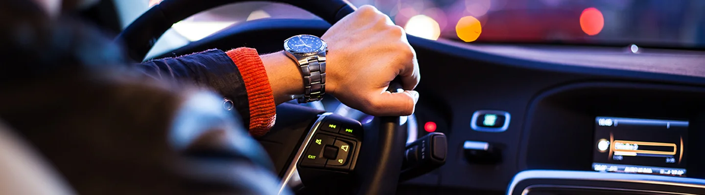 man driving car with smart phone
