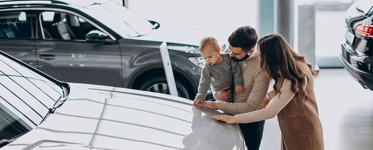 Family of three in showroom checking out new car for family
