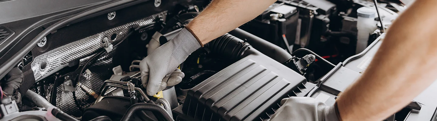 Service technician checking the oil on a vehicle