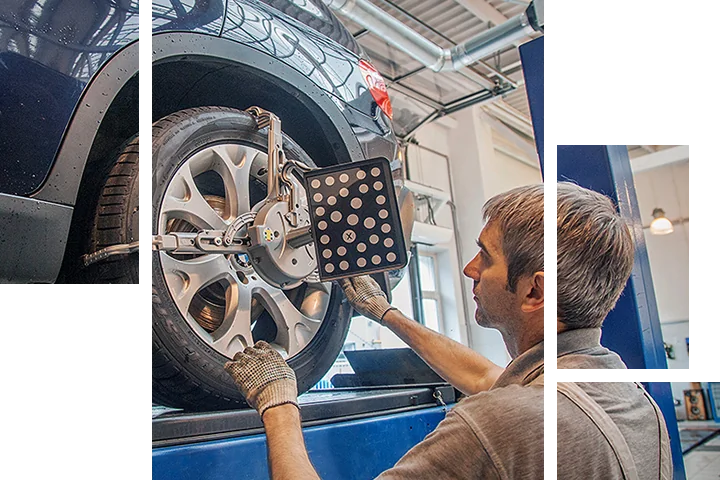 BMW service tech aligning tires on a car