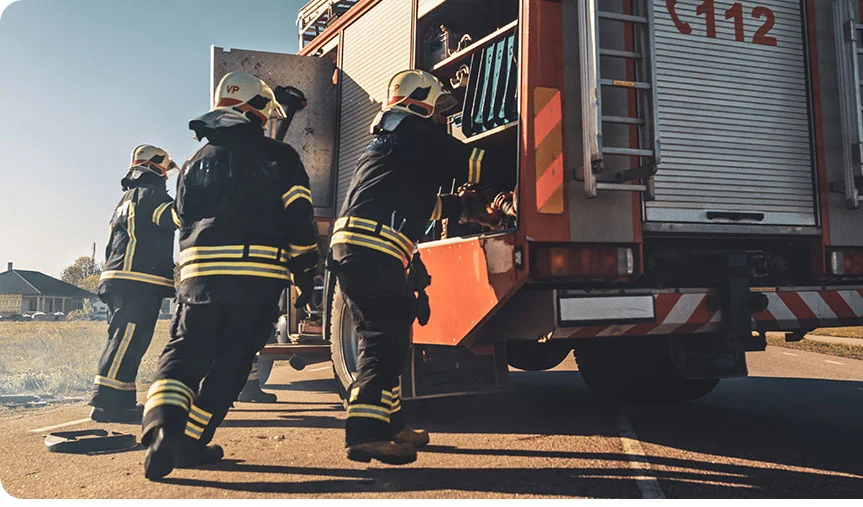 firemen unloading hose from their truck
