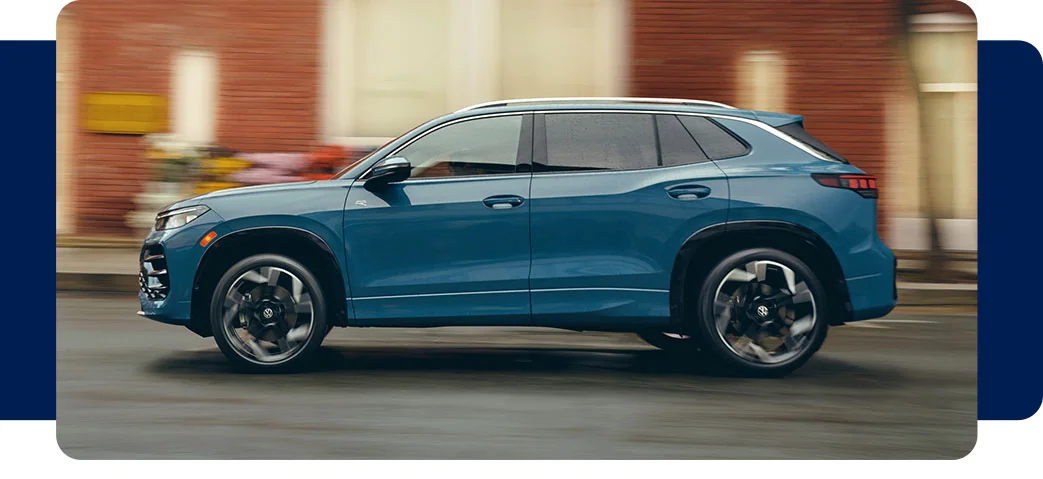 a blue Volkswagen car parked in city