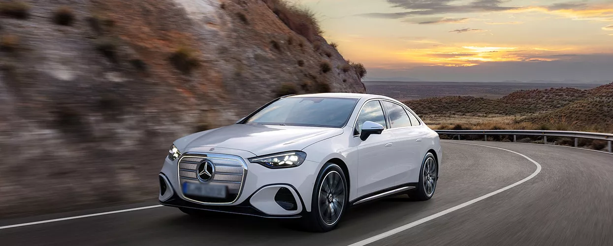 white Mercedes-Benz driving