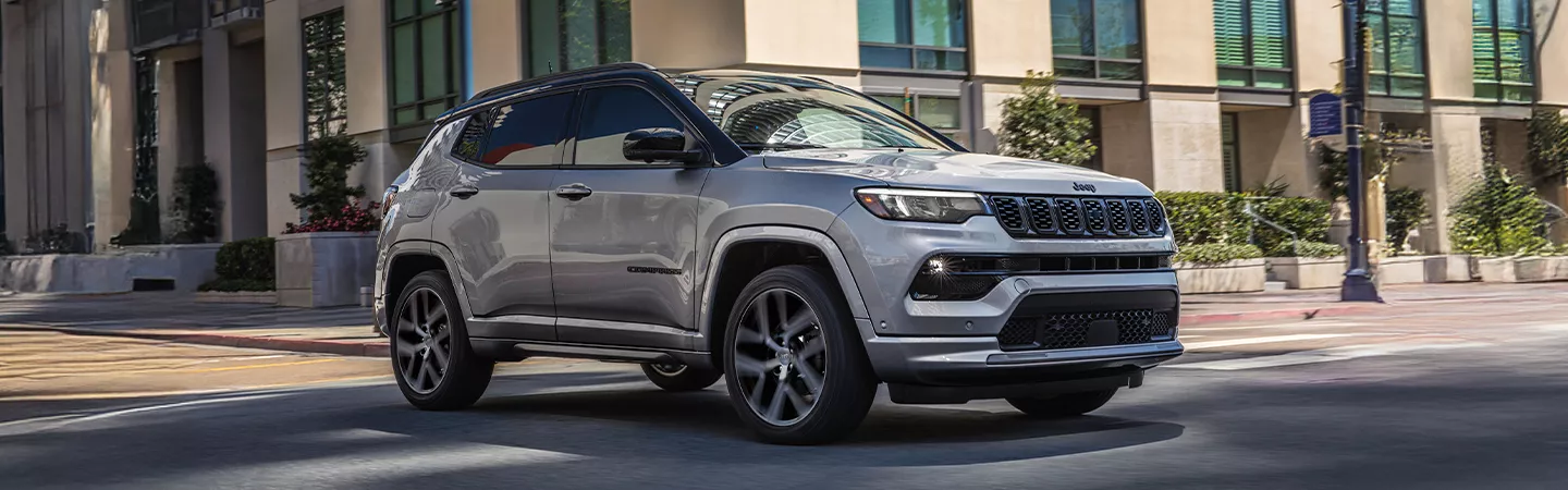 2025 Jeep Compass driving through the city in the daytime