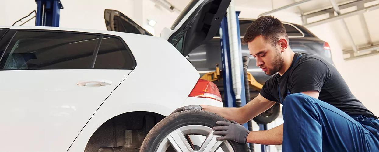 Service mechanic changing a vehicles tires