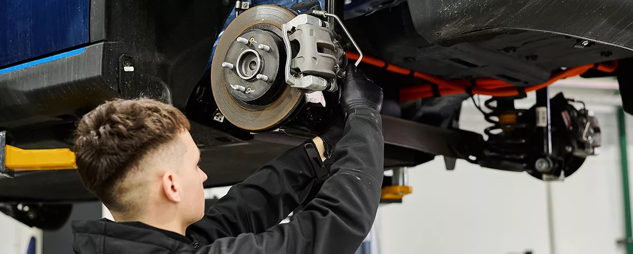Service mechanic servicing a vehicle's brakes