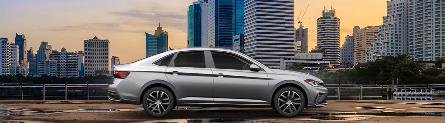 2025 Volkswagen Jetta parked in front of a city skyline