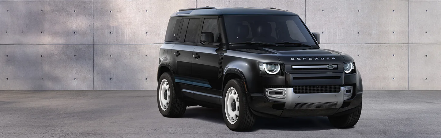 Front side view of a parked black 2025 Defender 110