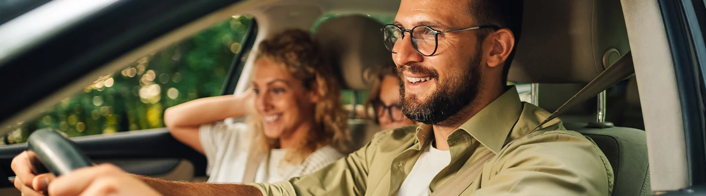 couple smiling driving a 2025 Volkswagen