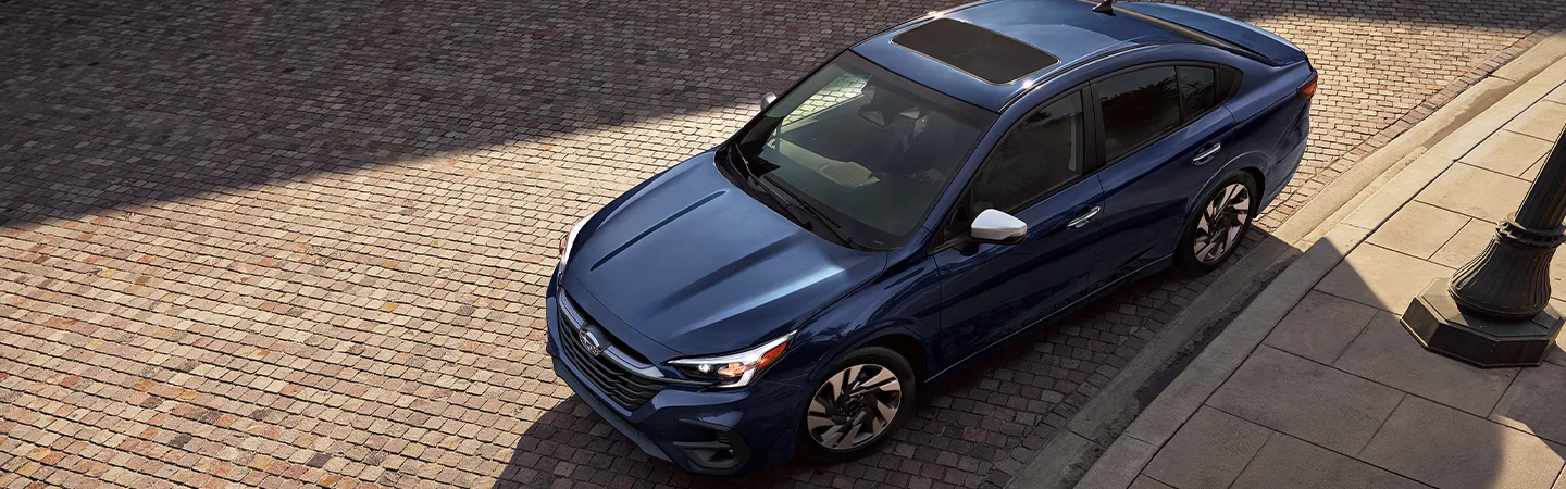 top view of a blue 2025 Subaru Legacy Touring XT parked on cobble stone road