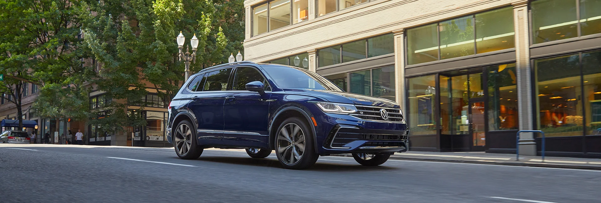 blue VW Tiguan crusing down Main St