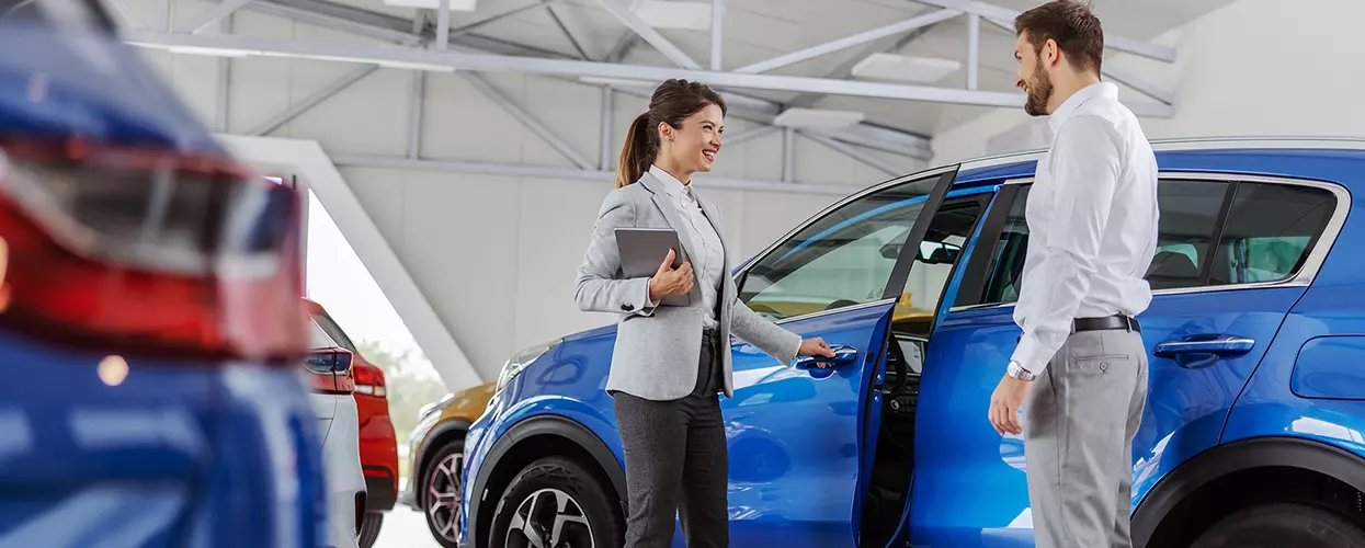Friendly dealership team member greeting a customer