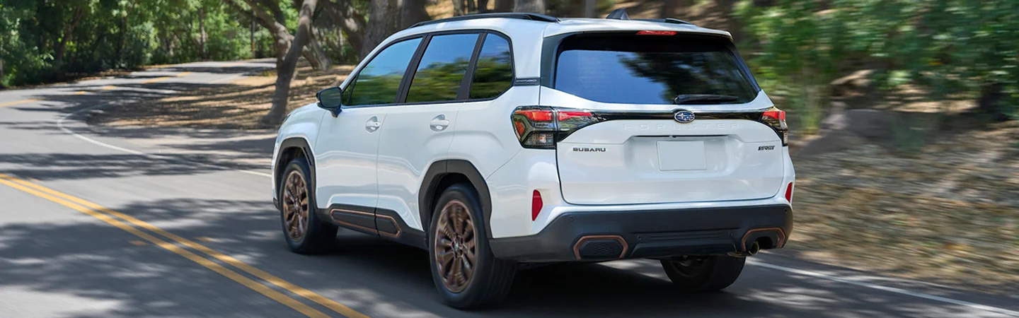 2025 Subaru Forester driving down a country road