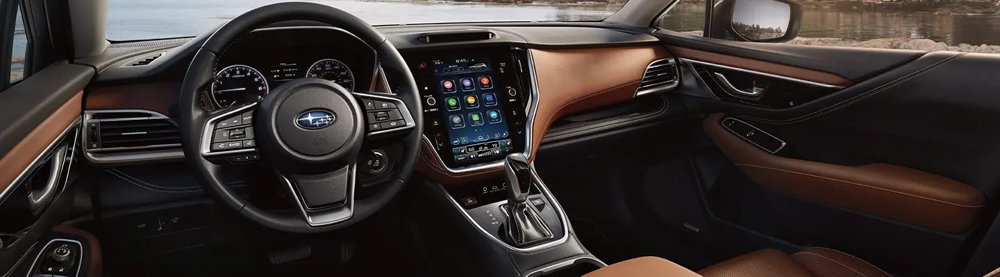 Interior image of the front seat and dashboard of a Subaru Outback