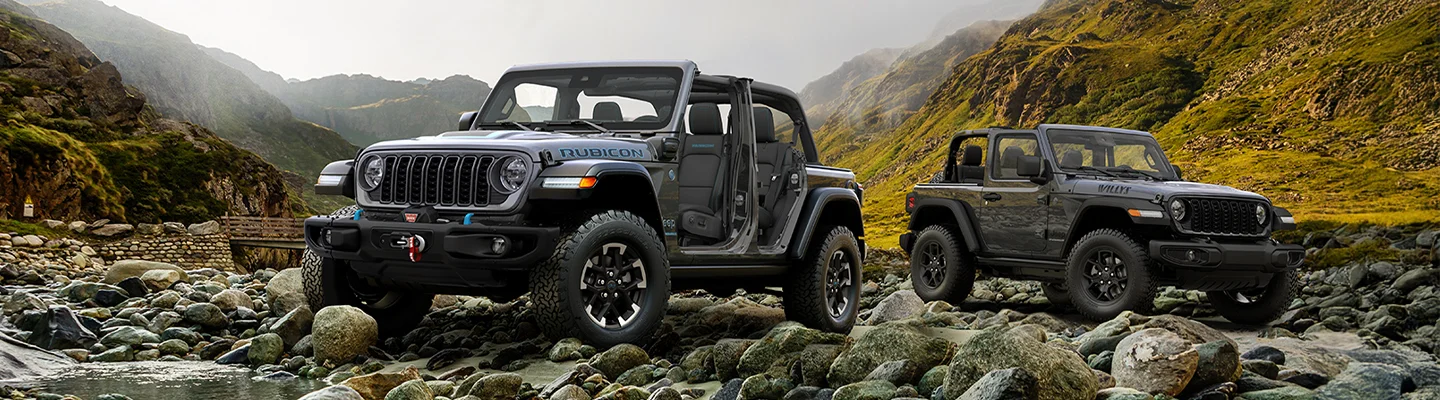 two electric Jeep models on rocks