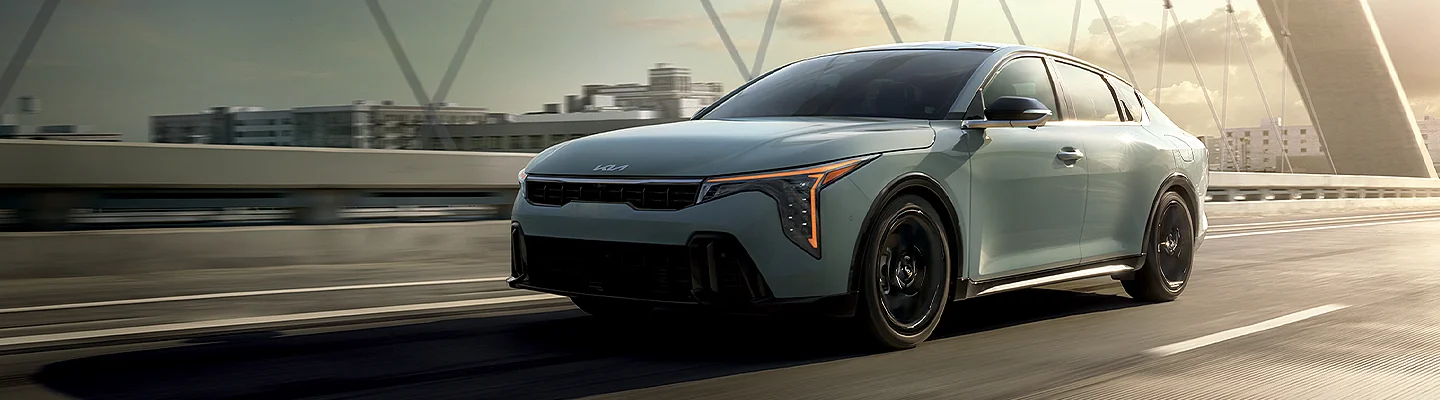 a light Blue Kia in motion