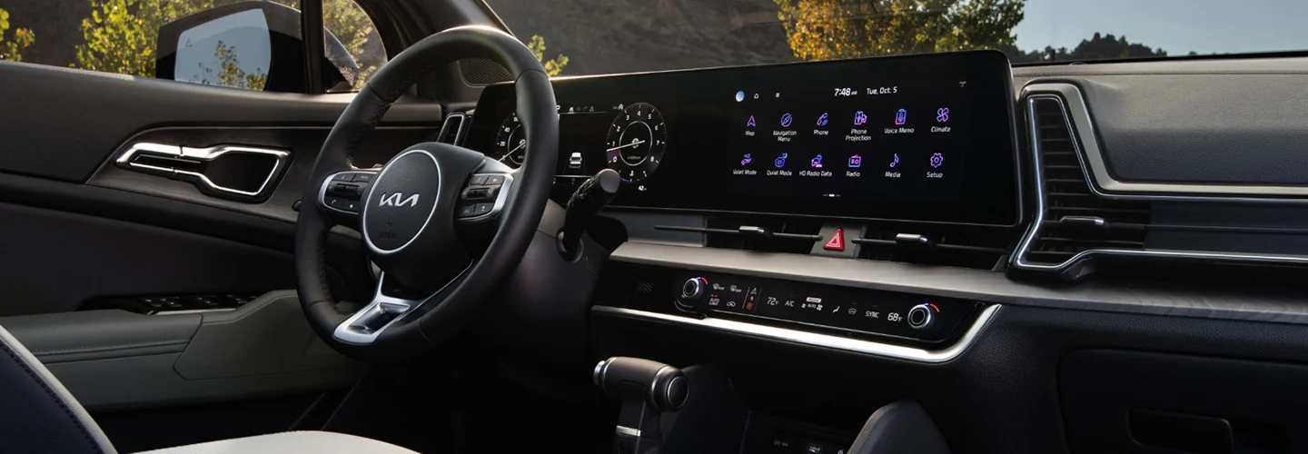 Interior view of the dashboard and tech for a 2025 Kia Sportage