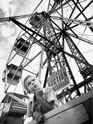 A young boy is shown at the foot of the Ferris wheel at Wedgewood, which closed in 1969.