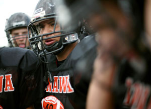 Stephen Cully and his teammates listen to instructions from a coach at Konawa High School in Konawa, Okla., on Monday, Aug. 29, 2011.