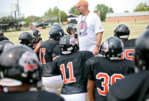 Konawa High School Head Football Coach Brent Damiel talks with his team before practice in Konawa, Okla., on Monday, Aug. 29, 2011.