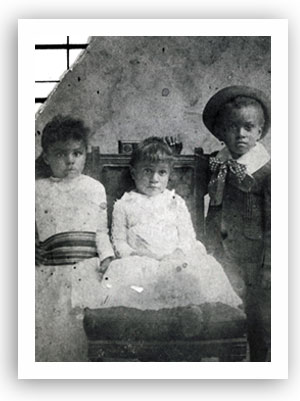 Three children - Nellie, Ollie, and William J. Matthews - in this studio portrait taken in Guthrie, Oklahoma Territory, circa 1900.