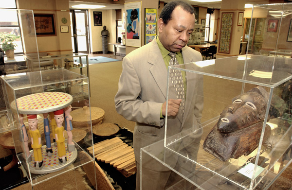 In this 2004 file photo Currie Ballard, who was Historian in Residence at Langston University at the time, looks over a wood mask from Baule, West Africa, which is part of the school's collection.