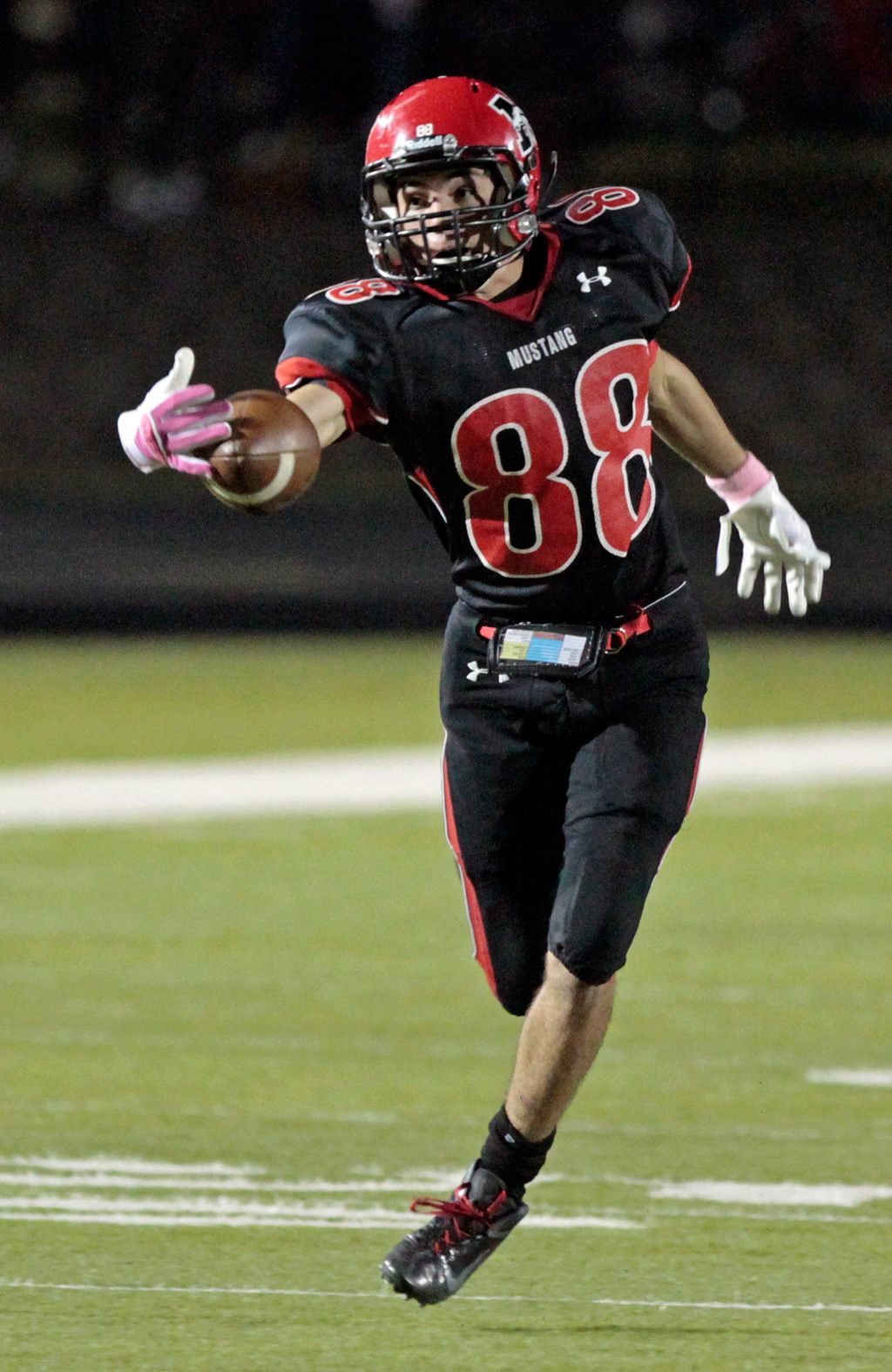Mustang's Dakota Warrington stretches and catches a pass as the Mustang Broncos play the Lawton Wolverines in high school football on Friday, September 23, 2011, Mustang, Oklahoma.