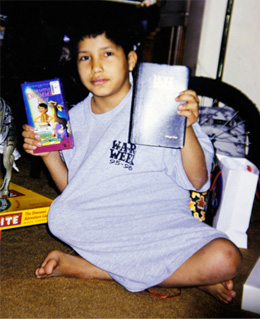  In this undated photo, young Miguel Rayos holds up several books including the Bible. 