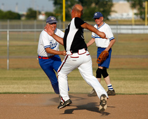Ray Rowland tries to tag an opposing player at the Plex Sports Complex in Oklahoma City, July 5, 2011.