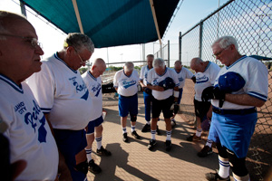 The Oklahoma City Royals softball team prays before a game July 5, 2011.