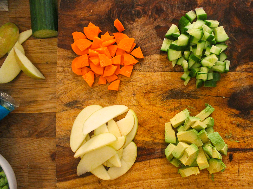 Chopped carrots, cucumber, avocado and apple.