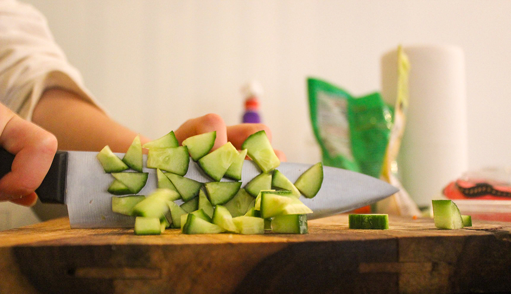 Daisy chopping cucumbers.