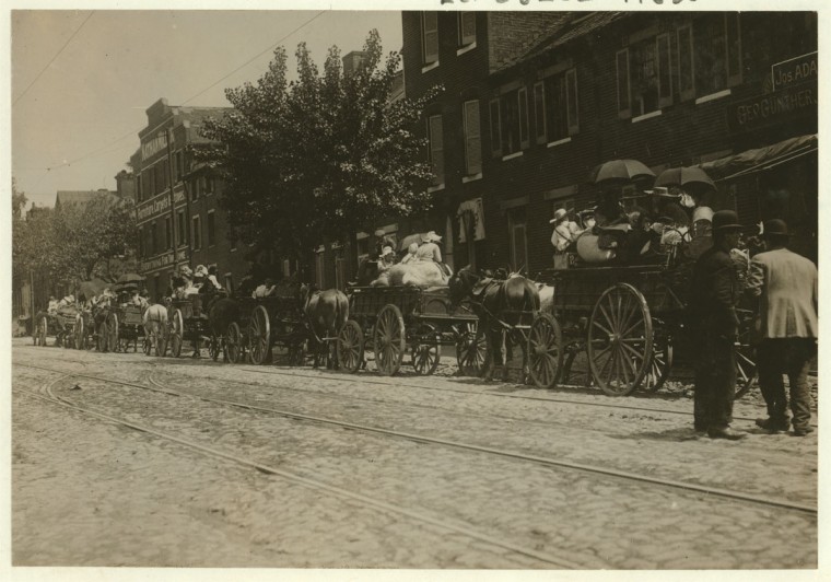 A street full of Baltimore immigrants lined up and ready to start for the country to the berry farms. Wolfe Street, near Canton Avenue, Baltimore, Maryland. Courtesy of Maryland Child Labor Committee. Location: Baltimore, Maryland. 1910 May. (Lewis Hine/Photo courtesy LOC)