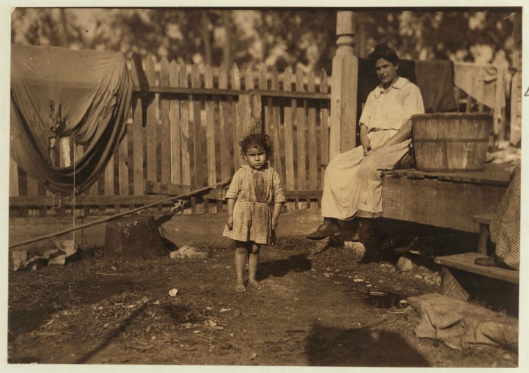Alma Crosien, three-year-old daughter of Mrs. Cora Croslen, of Baltimore. Both work in the Barataria Canning Company. The mother said, "I'm learnin' her the trade." Location: Biloxi, Mississippi. 1911 February (Lewis Hine/Photo courtesy LOC)