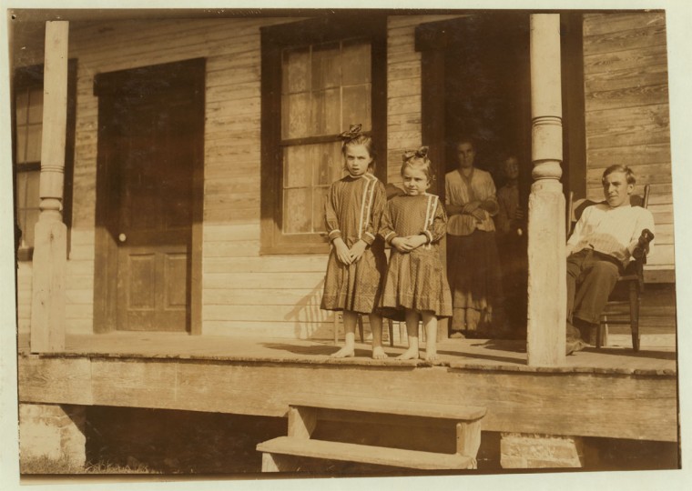 Bessie, four years old, and Marietta, seven years old, both shuck oysters in Barataria Canning Company. Mother is Mrs. Ida Thompson, Baltimore. Location: Biloxi, Mississippi. 1911 February. (Lewis Hine/Photo courtesy LOC)