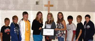 "Bricks for Haiti" Seventh-graders at All Saints Episcopal School, Morristown, hold $1,540 check for "Rebuild Our Church Haiti" appeal