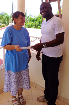 Dawn Adkins gives 20,500 gourdes to Yvon Jean Mahatma for the purchase of a mule for the Campan community in Leogane, Haiti. The funds were raised at a yard sale held by St. Luke's Church in Knoxvile where Adkins is a member. Dawn Adkins gives 20,500 gourdes to Yvon Jean Mahatma for the purchase of a mule for the Campan community in Leogane, Haiti. The funds were raised at a yard sale held by St. Luke's Church in Knoxvile where Adkins is a member.