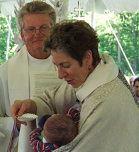 Presiding bishop, assisted by the Rev. John Hines, baptises a baby at All Saints Conference Center in Leitchfield